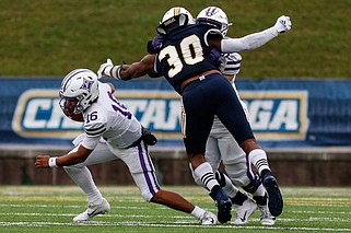 Staff file photo / UTC edge rusher Jay Person (30) tries to get past a Furman offensive lineman to pressure quarterback Jace Wilson (16) during a SoCon game at Finley Stadium. Person, a Bradley Central High School graduate, has received an invitation to an NFL rookie camp from the New England Patriots.